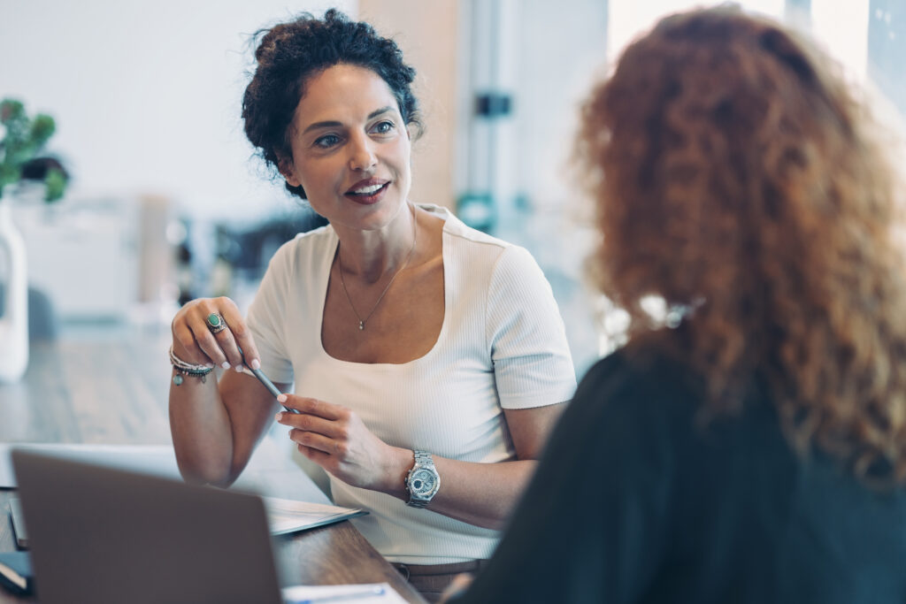 Functional Pathway Assessment. Injury Management. Two businesswomen talking in an office