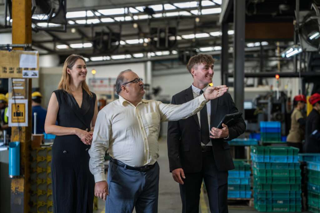 Insurers visiting a business for risk assessment in a factory